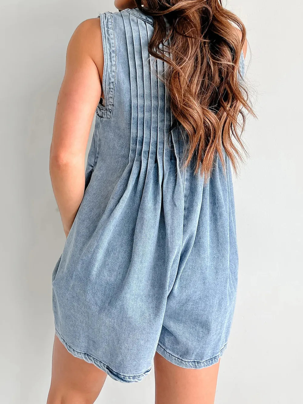 Light blue tied romper with pockets by Trendsi, featuring a stylish design and comfortable fit, suitable for casual wear.