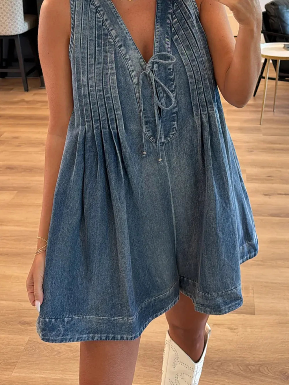 Light blue tied romper with pockets from Trendsi, featuring a relaxed fit and casual style, ideal for warm weather.