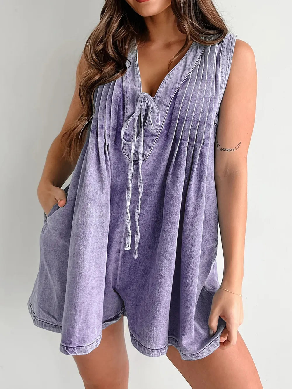 Light-blue tied romper with pockets from Trendsi, featuring a stylish design and comfortable fit.