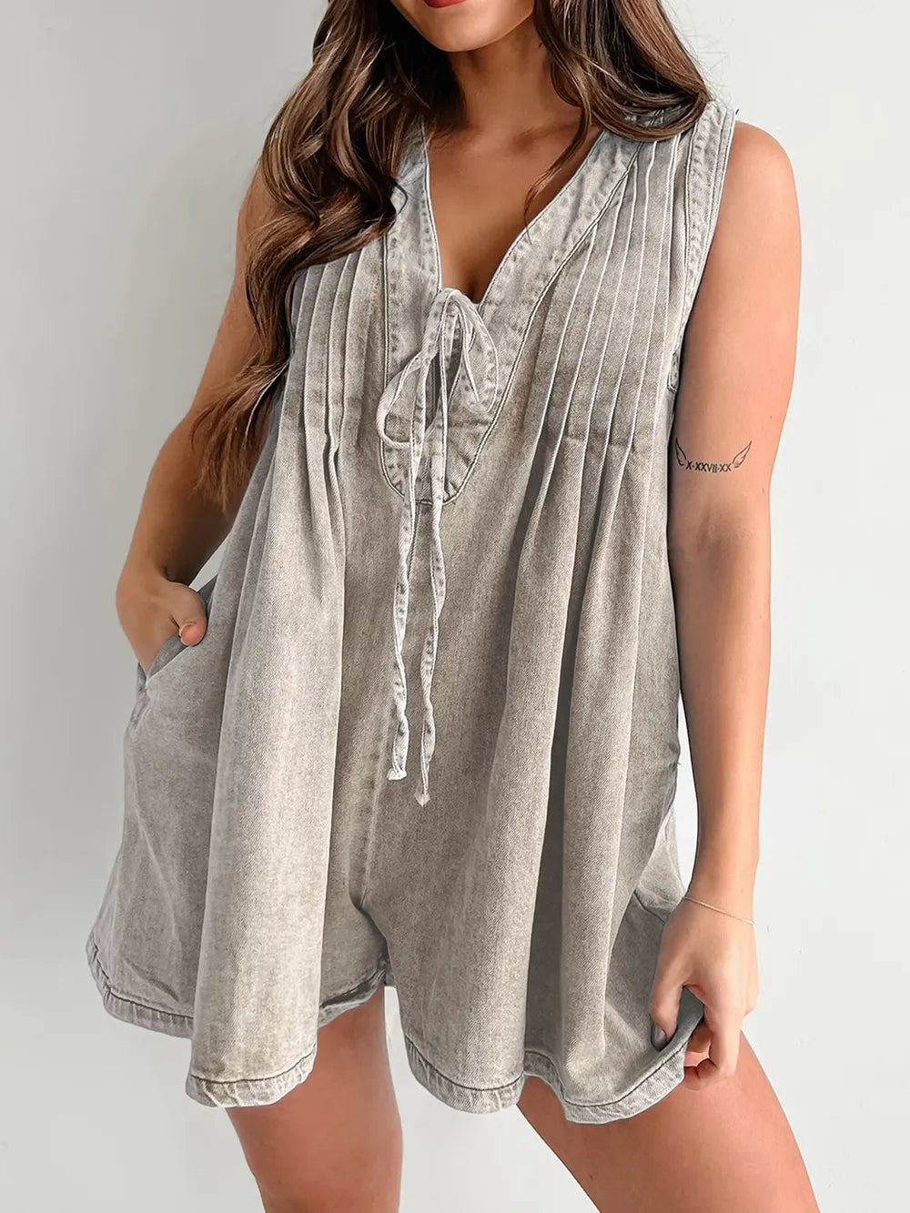 Light blue tied romper with pockets from Trendsi, featuring a relaxed fit and stylish design for casual wear.