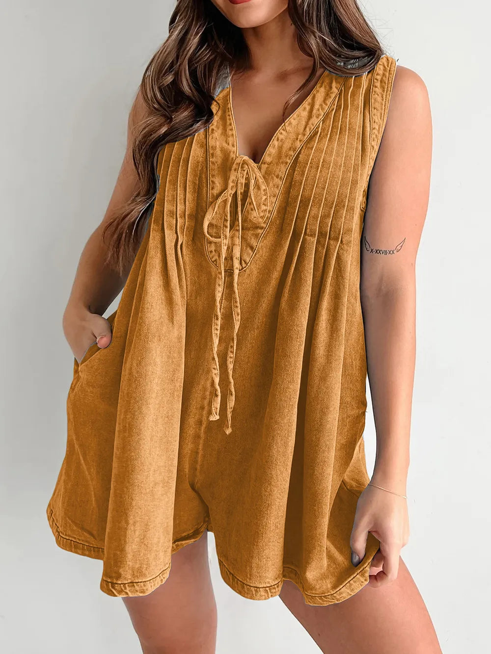 Light-blue tied romper with pockets from Trendsi, featuring a casual fit and stylish design, perfect for warm weather.