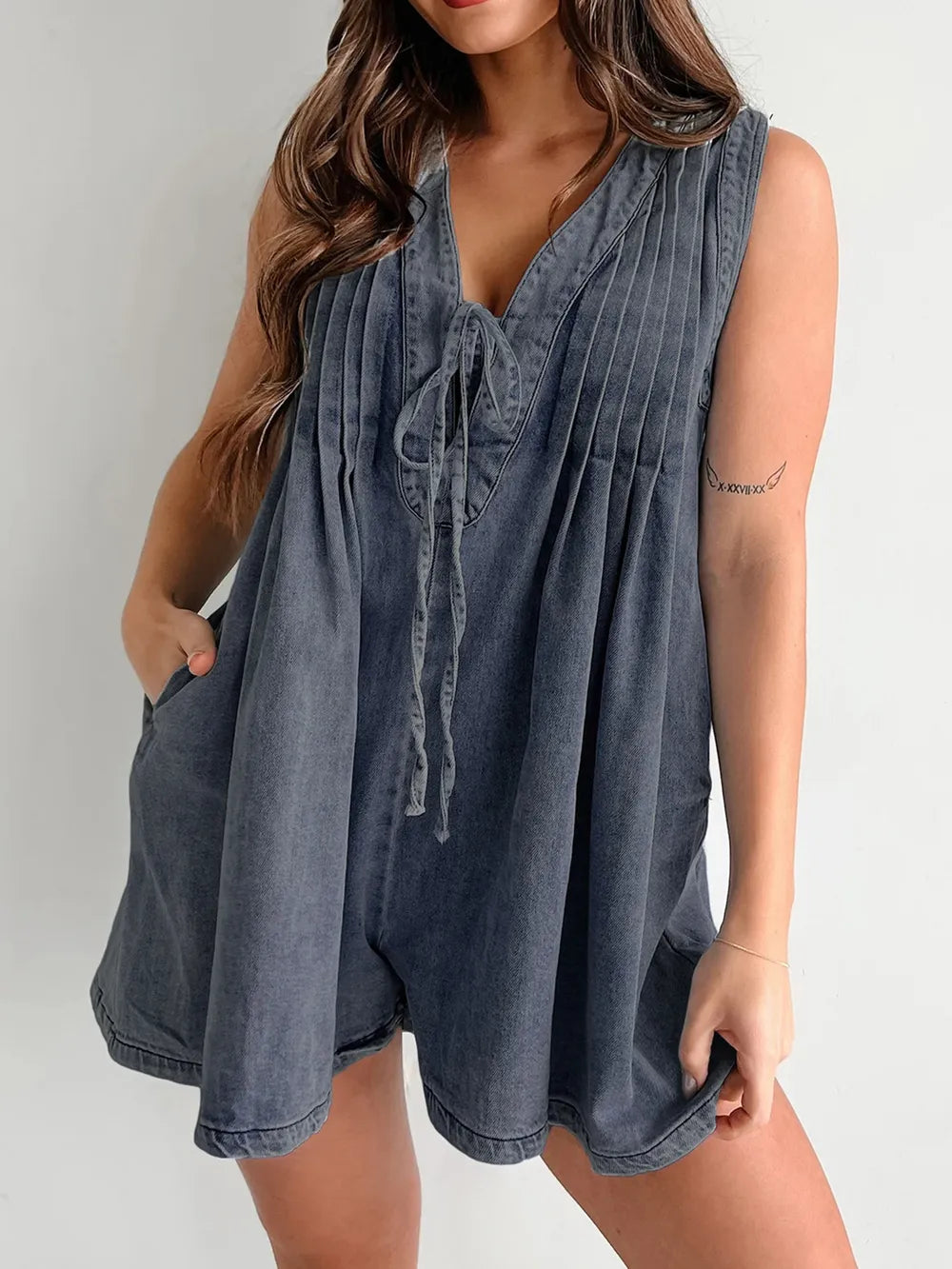 Light-blue tied romper with pockets from Trendsi, featuring a relaxed fit and casual style, suitable for warm weather.