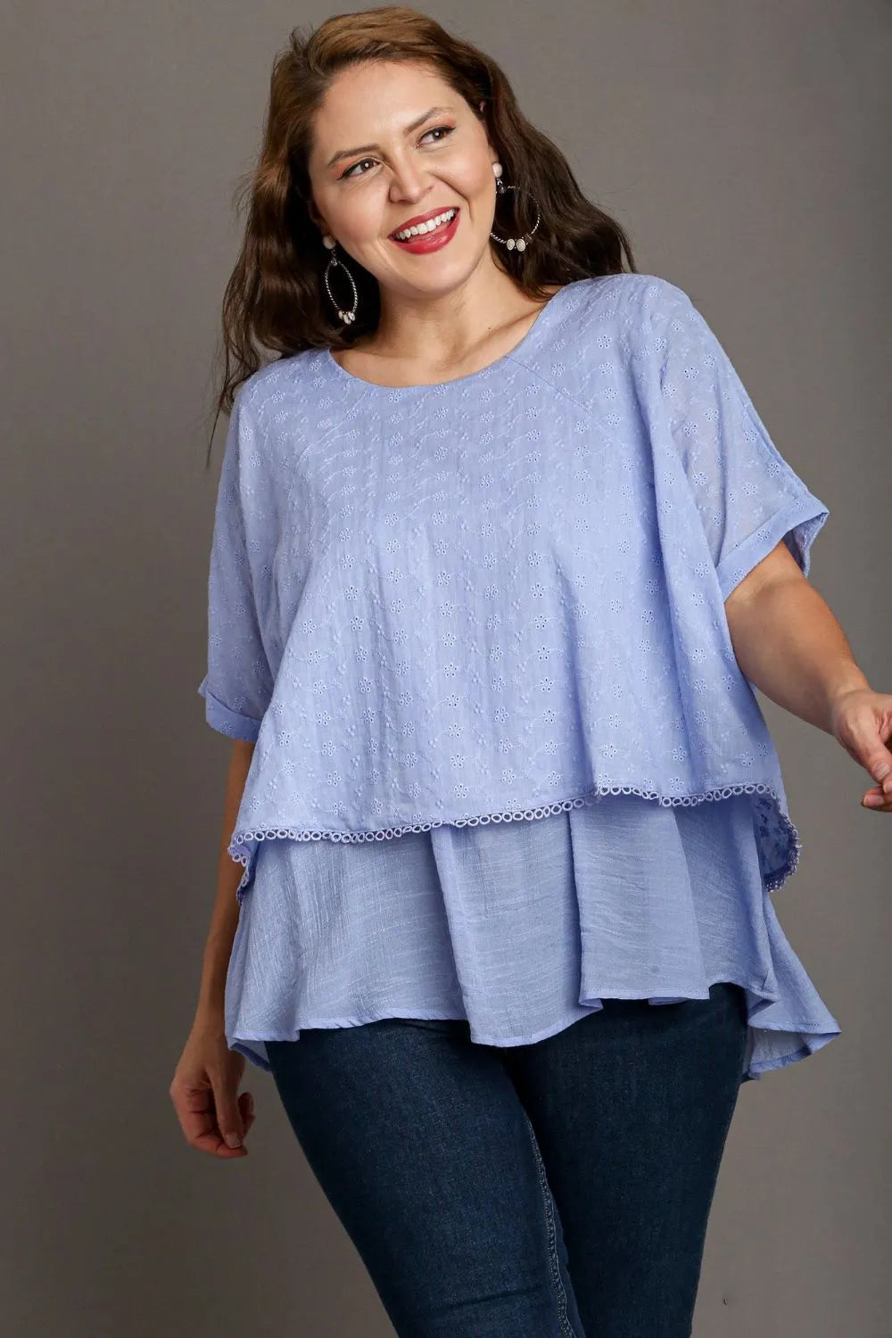 Light blue plus size Umgee eyelet layered short sleeve blouse with eyelet details, casual and stylish for everyday wear.