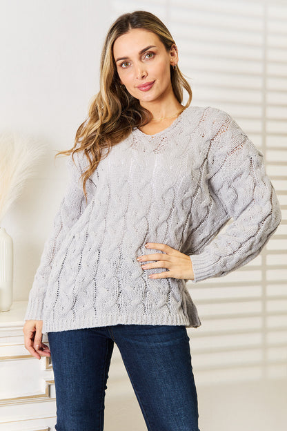Light gray woven cable-knit hooded sweater from Trendsi featuring a right cable design and cozy fit.