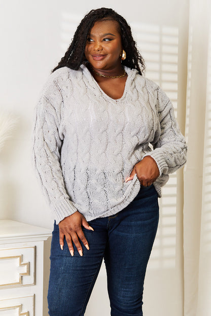 Light gray woven cable-knit hooded sweater from Trendsi, featuring a cozy, textured design and a comfortable fit.