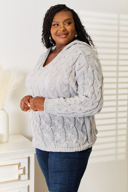 Light gray woven right cable-knit hooded sweater from Trendsi, featuring textured knit and a comfortable fit.