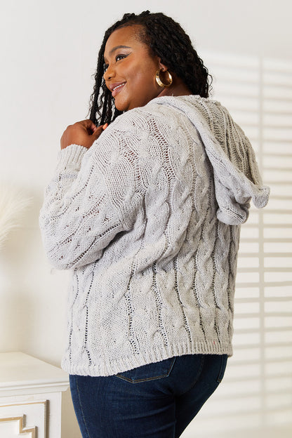 Light gray woven cable-knit hooded sweater by Trendsi featuring a cozy, textured cable pattern and a relaxed fit.