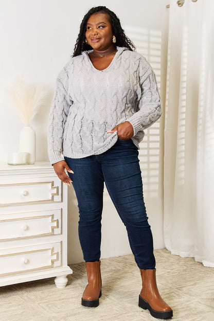 Light gray woven cable-knit hooded sweater by Trendsi, featuring a cozy, textured cable design and a comfortable fit.