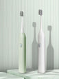 Light green portable electric toothbrush from Trendsi with a compact design and one-size fits all brush head.