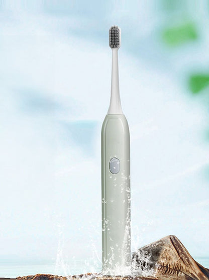 Light green portable electric toothbrush by Trendsi, compact design with brush head and handle visible.