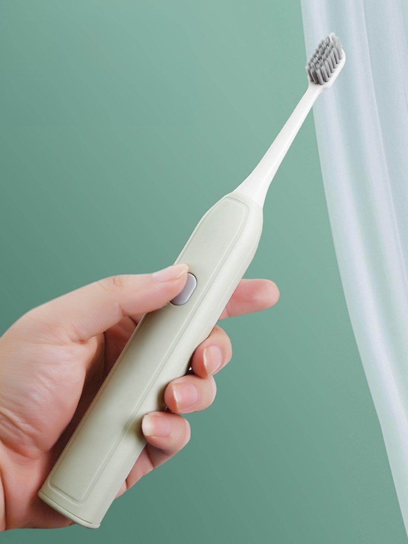 Light green portable electric toothbrush by Trendsi with a compact design and one-size-fits-all brush head.