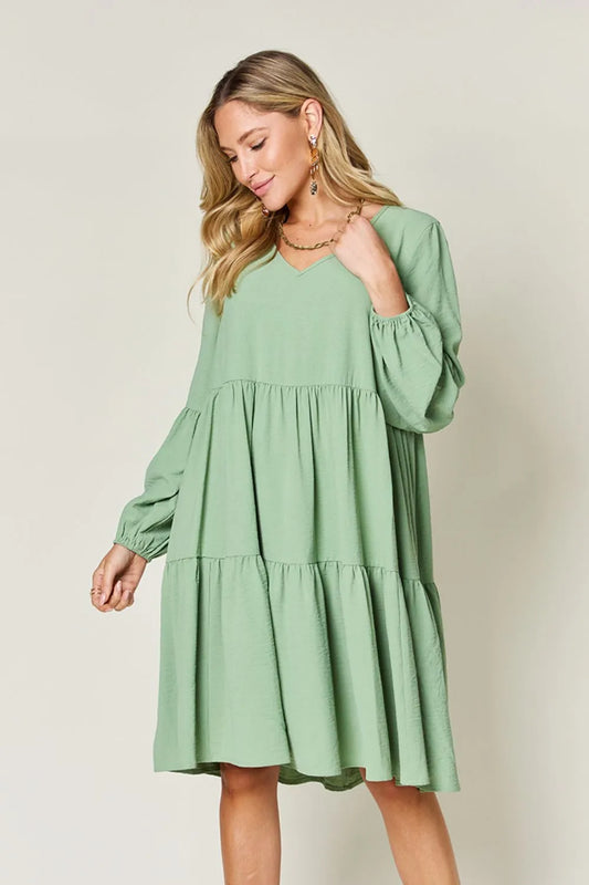 Light green Trendsi Double Take full-size V-neck balloon sleeve tiered dress with pockets, stylish and comfortable for everyday wear.