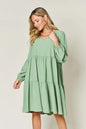 Light green Trendsi Double Take full-size V-neck balloon sleeve tiered dress with pockets, stylish and comfortable for everyday wear.