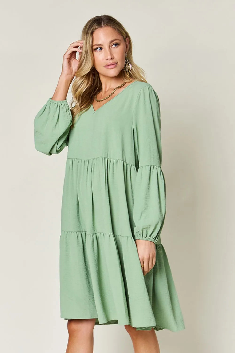 Light green Trendsi Double Take full-size V-neck balloon sleeve tiered dress with pockets, stylish and comfortable for everyday wear.