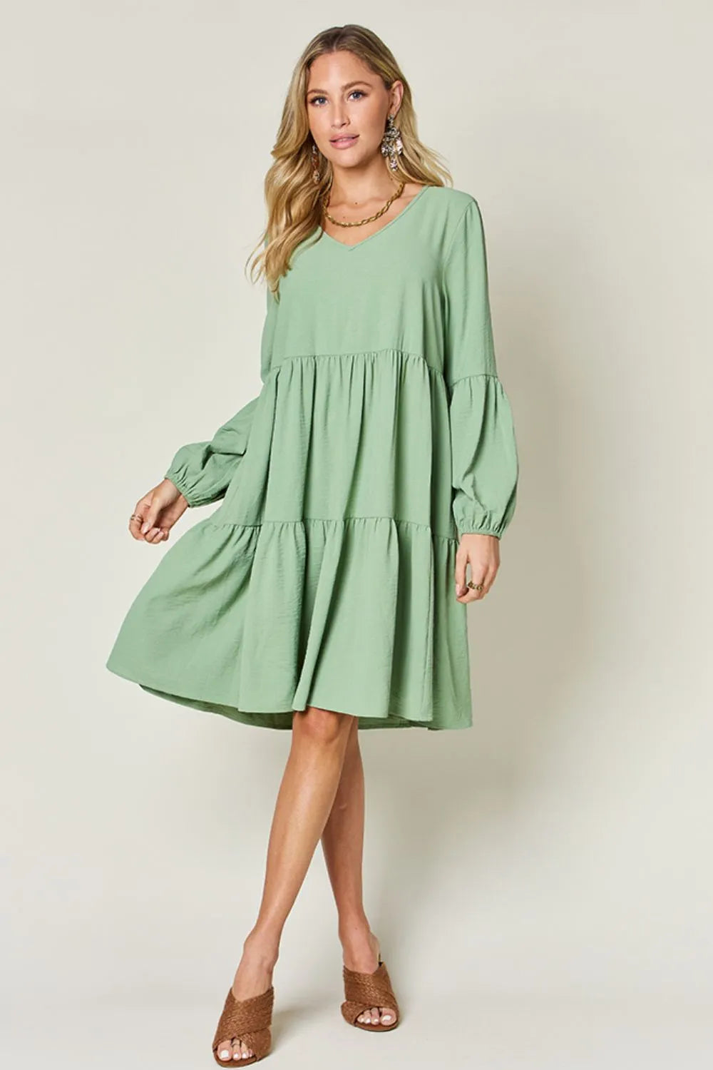 Light green Trendsi Double Take full-size V-neck balloon sleeve tiered dress with pockets, showcasing a stylish and comfortable design.