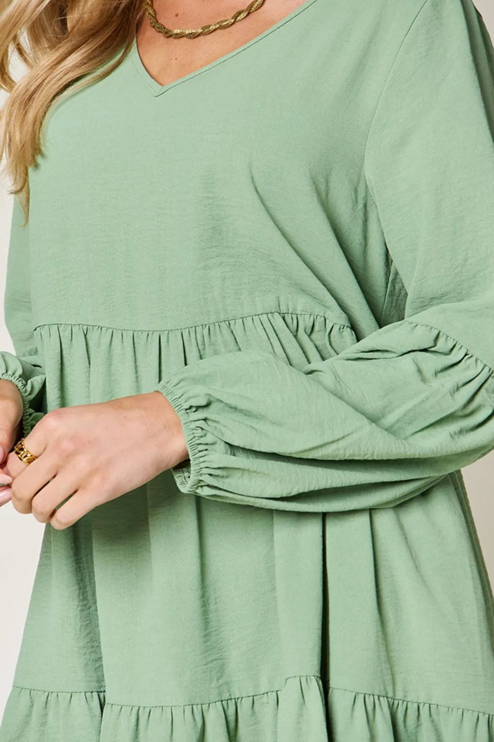 Light green Trendsi double take full-size V-neck balloon sleeve tiered dress with pockets, showcasing a flowing, stylish design.