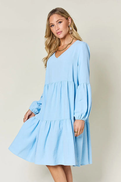 Light green Trendsi Double Take full-size V-neck balloon sleeve tiered dress with pockets, stylish and comfortable for casual wear.