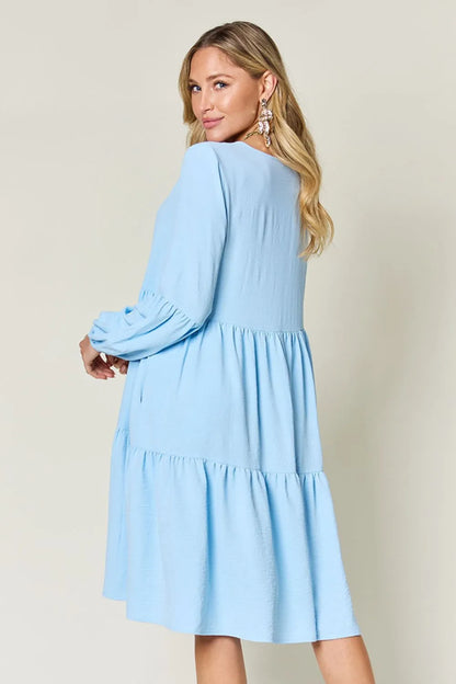 Light green Trendsi Double Take full-size V-neck balloon sleeve tiered dress with pockets, stylish and comfortable for casual wear.