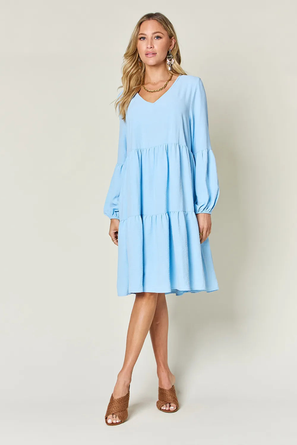 Light green Trendsi Double Take full-size V-neck balloon sleeve tiered dress with pockets, featuring a stylish and flowy design.