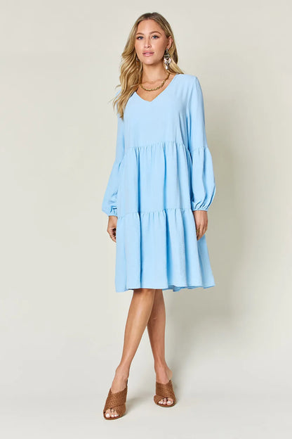 Light green Trendsi Double Take full-size V-neck balloon sleeve tiered dress with pockets, featuring a stylish and flowy design.