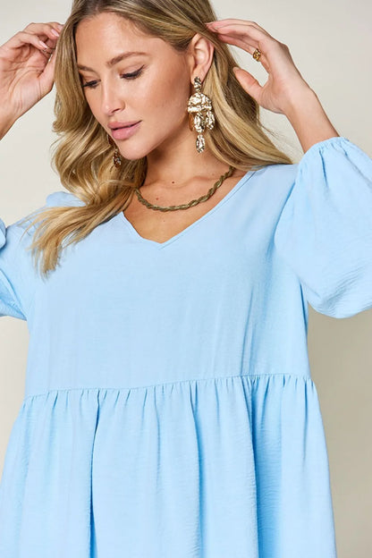 Light green Trendsi Double Take full-size V-neck balloon sleeve tiered dress with pockets, stylish and comfortable for everyday wear.