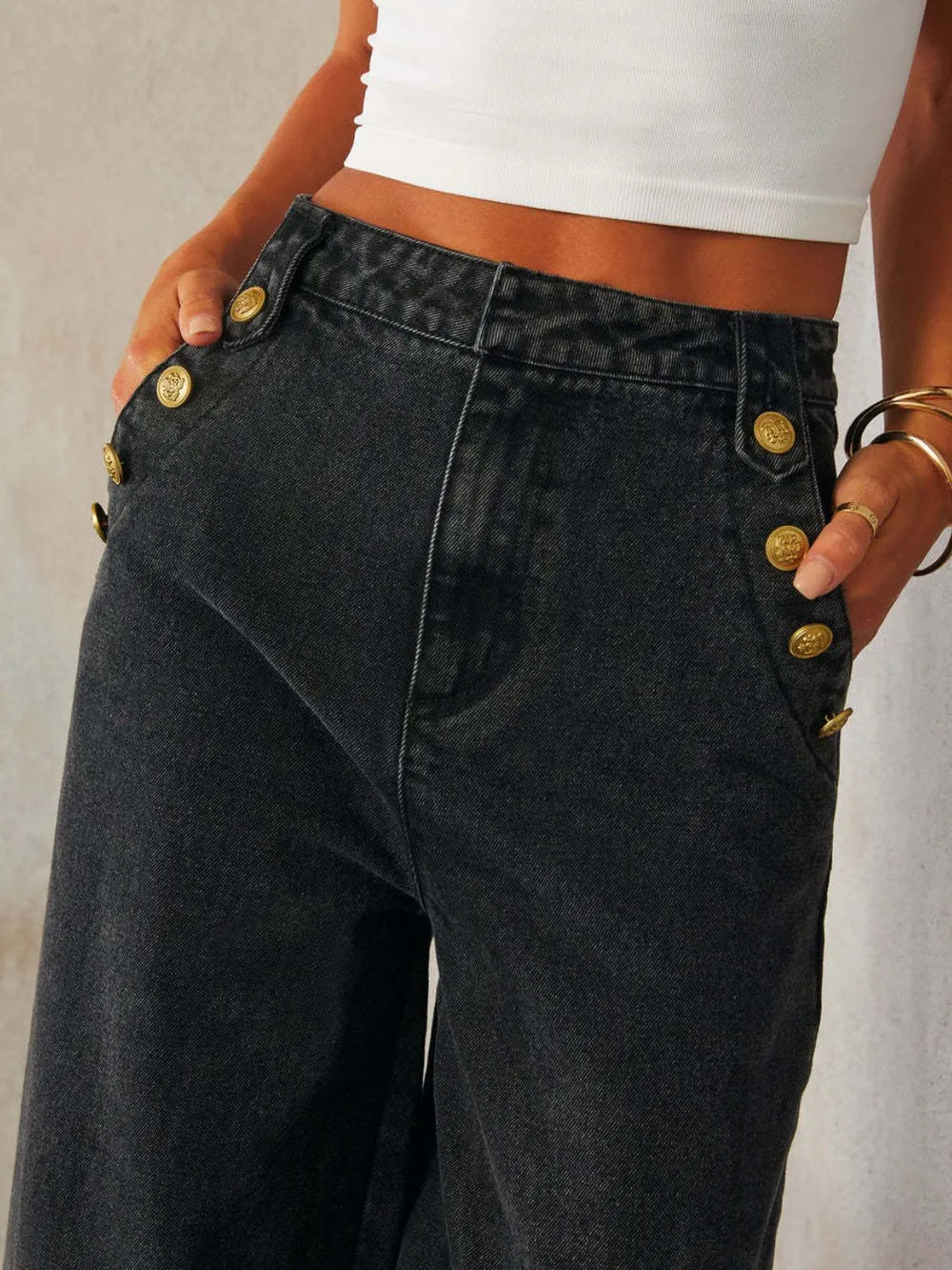 Light wash button decor high-rise wide-leg jeans from Trendsi featuring a relaxed fit and classic denim style.