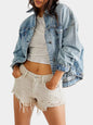 Light wash button-up long sleeve denim jacket by Trendsi, shown on a hanger with classic collar and front pockets.