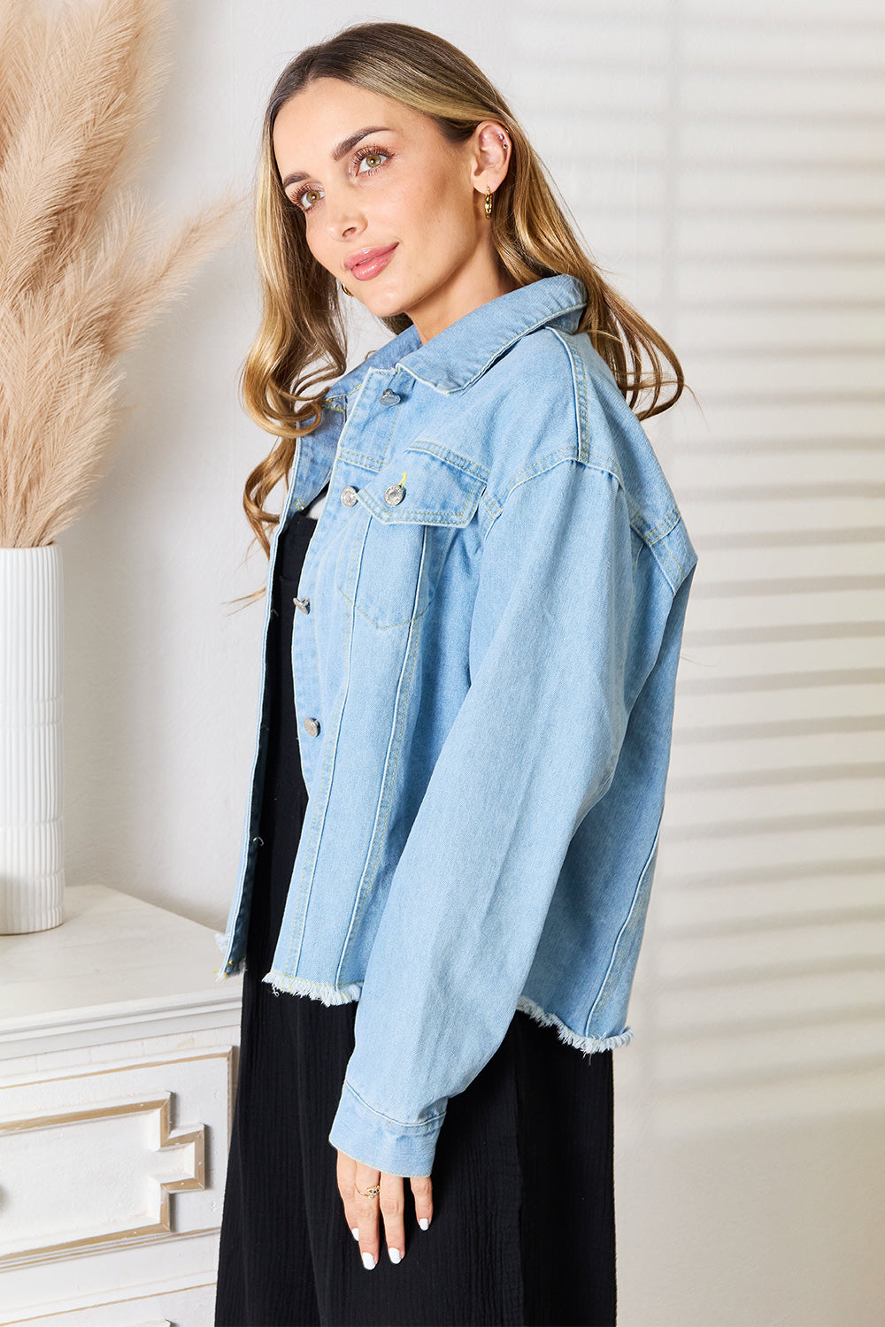 Light wash Trendsi Double Take dropped shoulder raw hem denim jacket with relaxed fit and stylish design.
