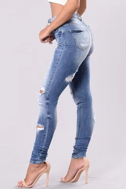 Plus size full length distressed skinny jeans from Trendsi, showcasing a fitted, ripped style with a casual, trendy look.