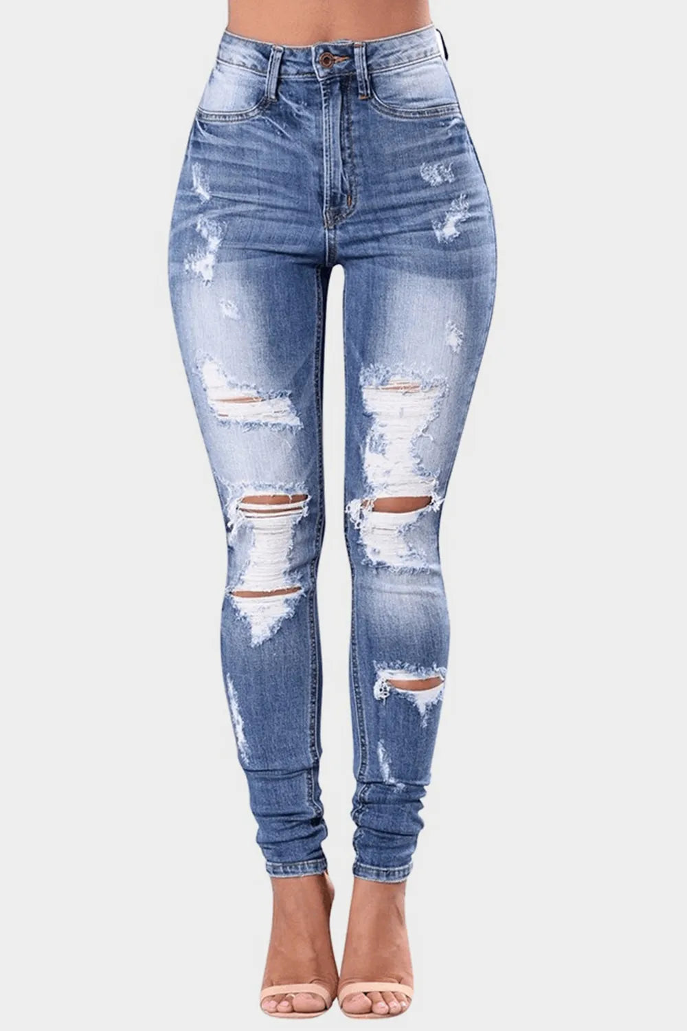 Full size distressed skinny jeans by Trendsi, plus size, showing a fitted design with rips and fading on denim fabric.
