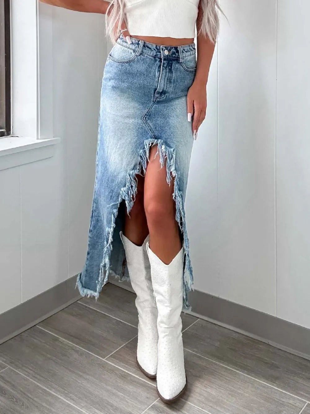 Light wash high-waist raw hem asymmetry denim skirt from Trendsi, featuring uneven hem and stylish silhouette.