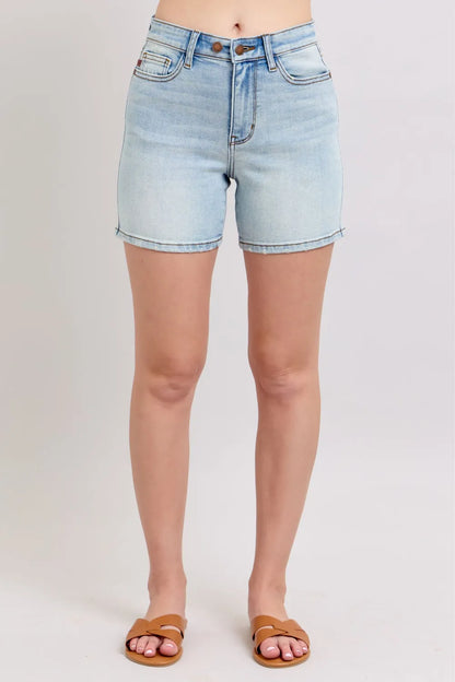 Light blue Judy Blue denim shorts with 2 buttons, pockets, and plus size fit, featuring a casual, relaxed style.