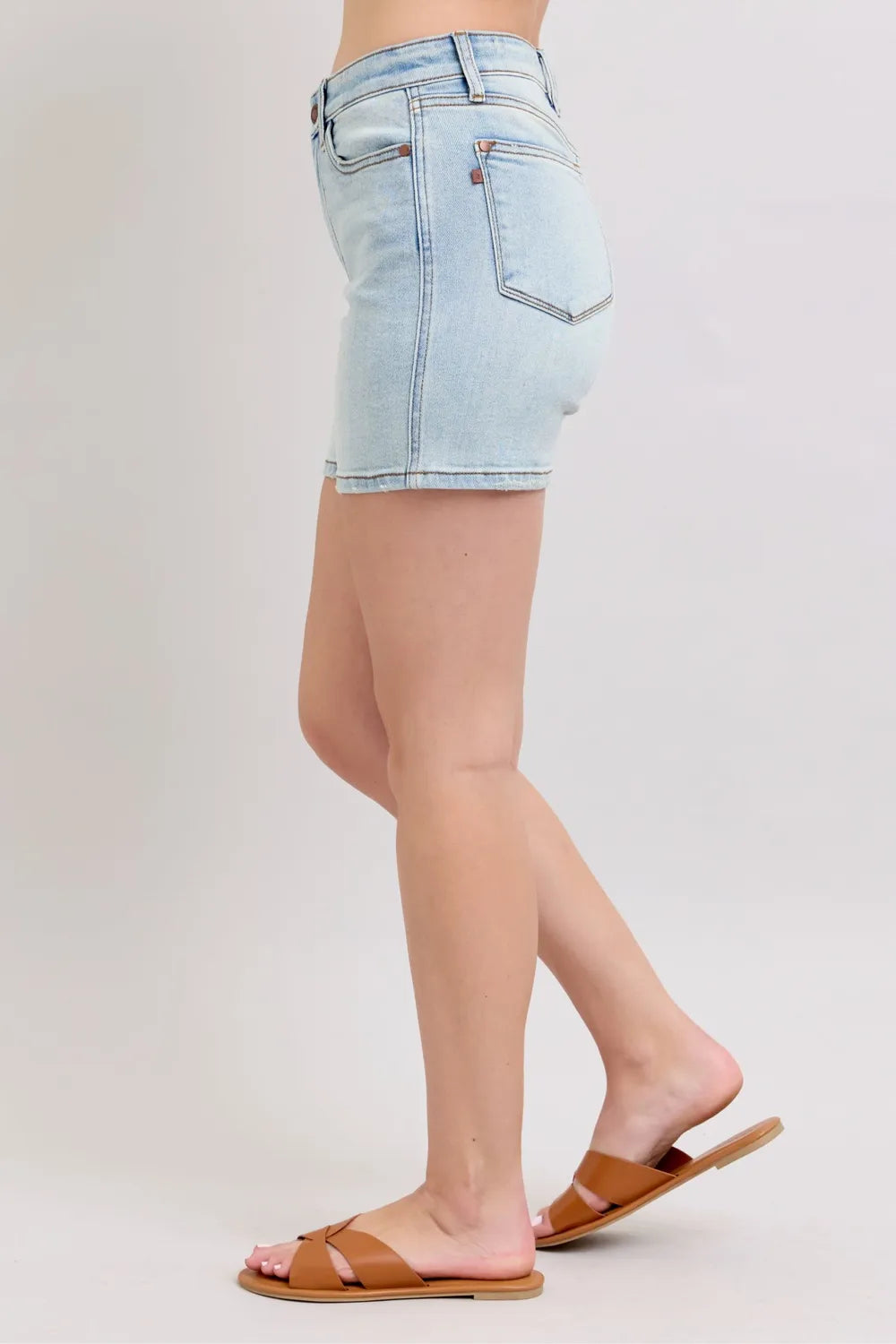 Light blue Judy Blue denim shorts with two buttons and pockets, designed for plus size, featuring a casual, trendy fit.