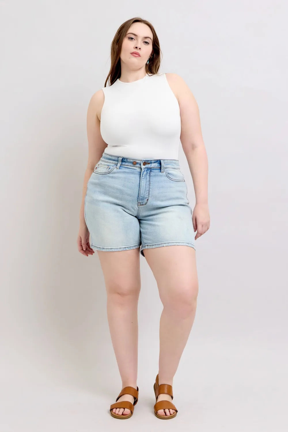 Light blue Judy Blue plus size denim shorts with two buttons and front pockets, casual and stylish for everyday wear.