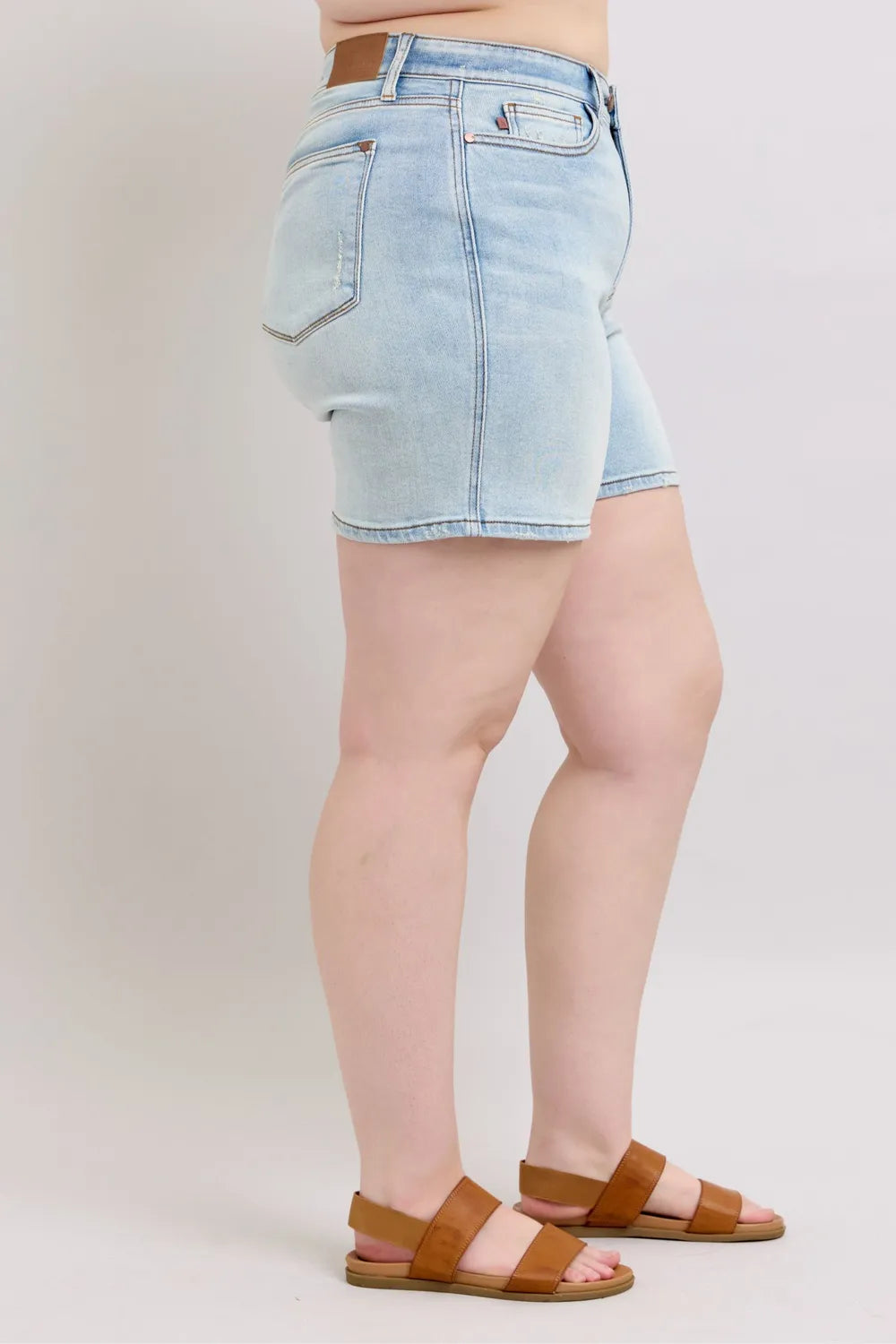 Light blue Judy Blue full-size denim shorts with two buttons and pockets, designed for plus-size women.