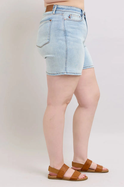 Light blue Judy Blue full-size denim shorts with two buttons and pockets, designed for plus-size women.