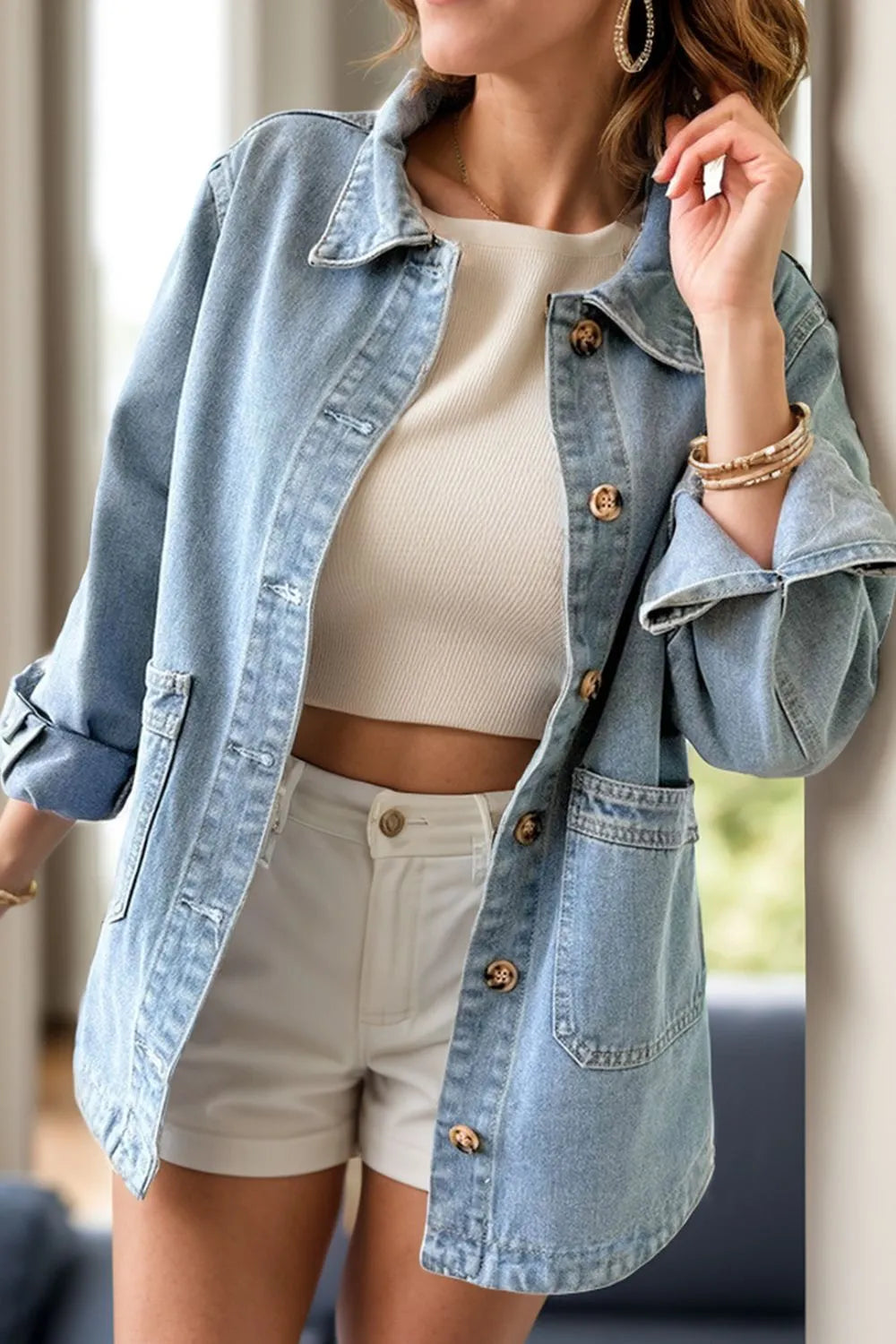 Light blue denim jacket with chest pockets and button-up front, long sleeves, by Trendsi, casual and stylish for everyday wear.