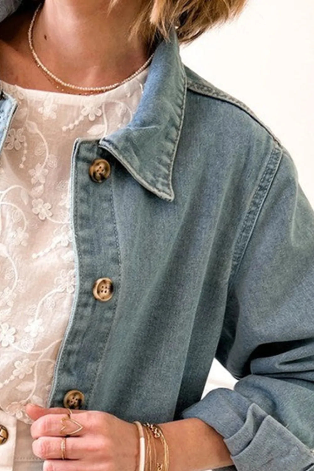 Light wash denim jacket with pockets, button-up long sleeve style from Trendsi, perfect for casual wear.