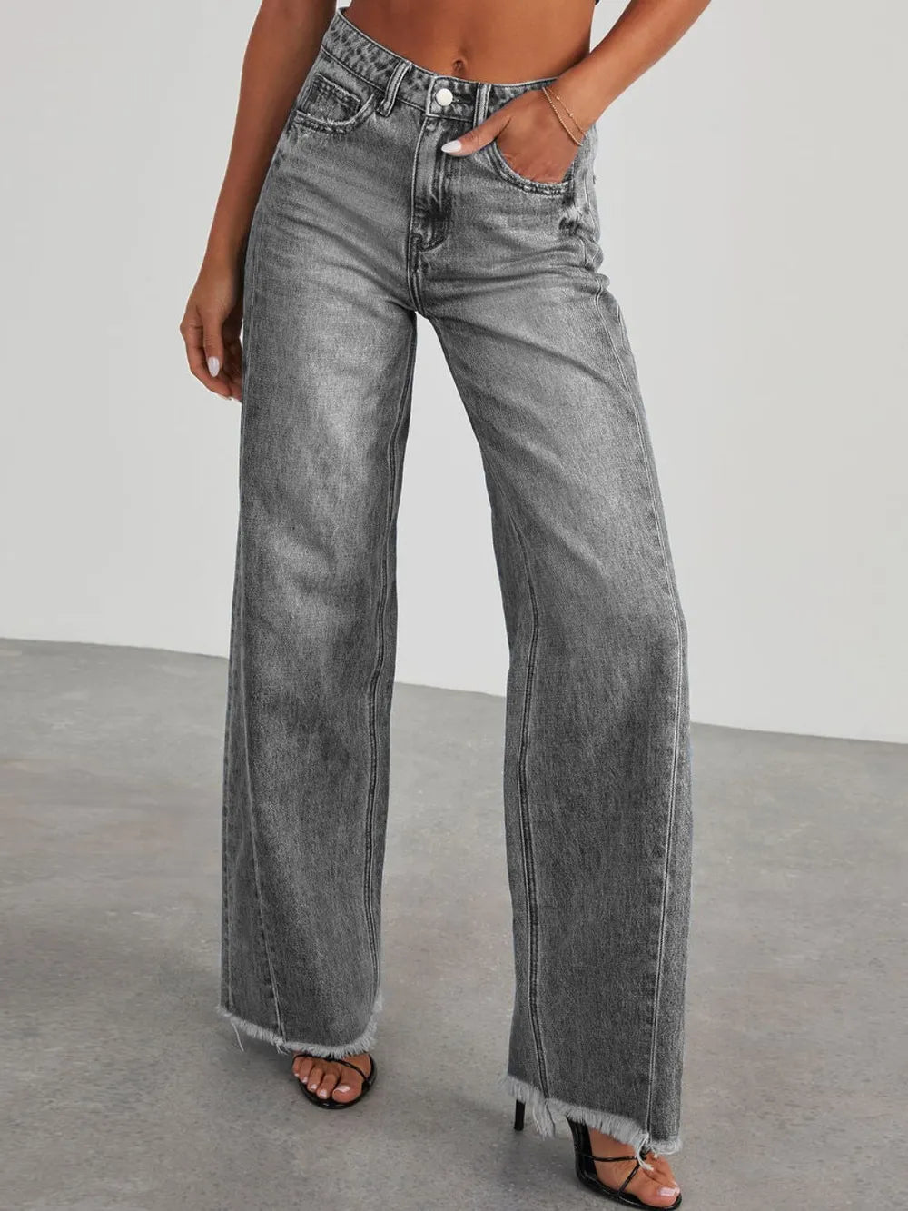 Light wash raw hem wide-leg jeans with pockets from Trendsi, featuring a relaxed fit and stylish design.
