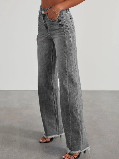 Light wash raw hem wide leg jeans with pockets from Trendsi, featuring a relaxed fit and stylish design.