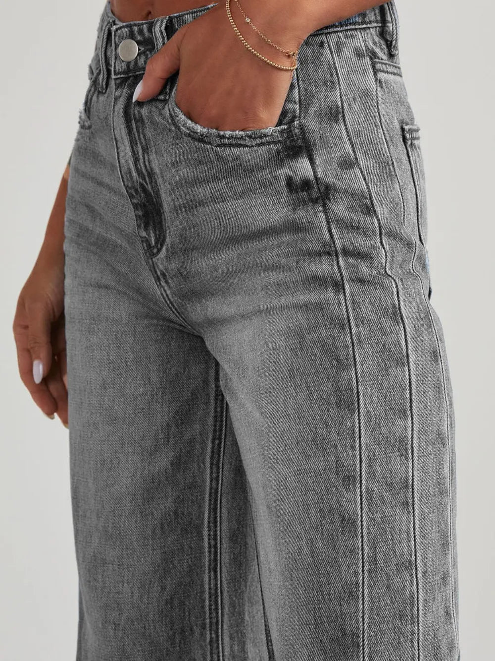 Light wash raw hem wide-leg jeans from Trendsi with side pockets, relaxed fit, and casual style.