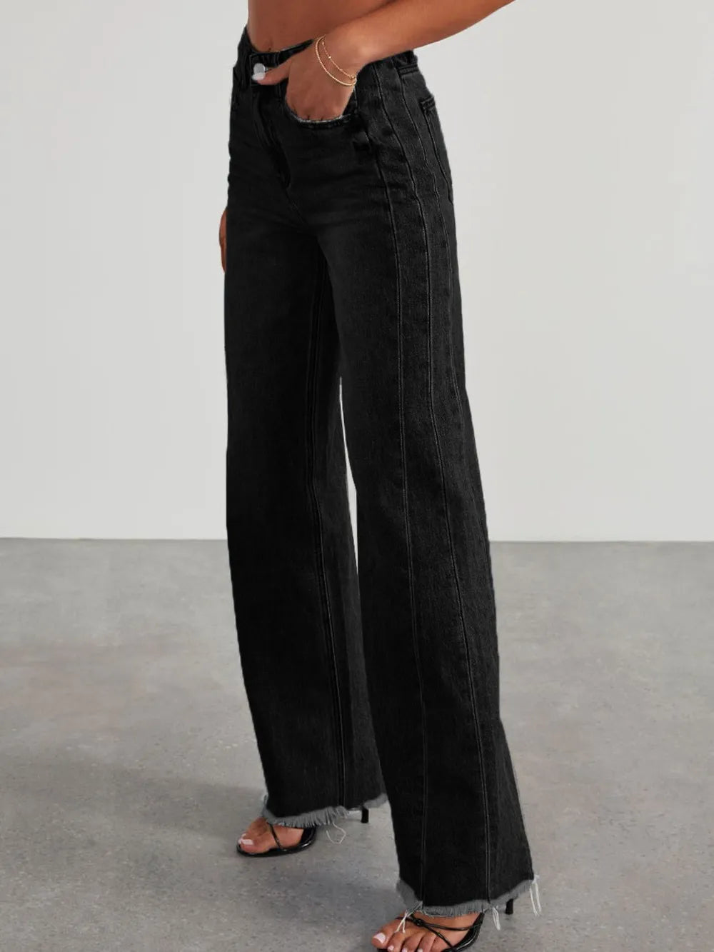 Light wash raw hem wide-leg jeans with pockets from Trendsi, showcasing relaxed fit and casual style.