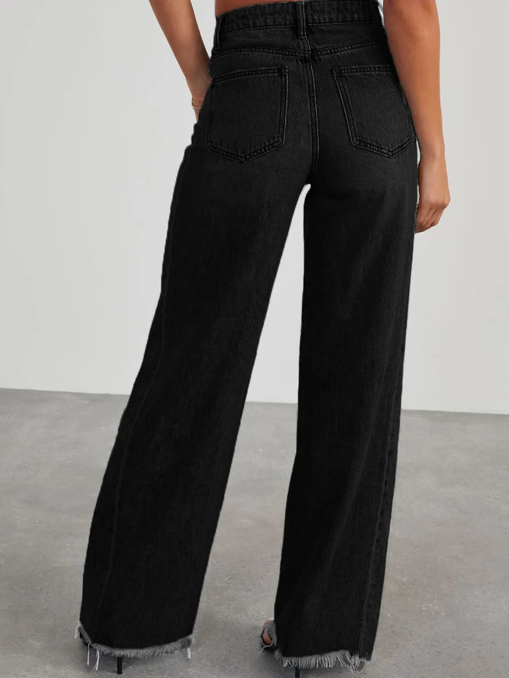 Light wash raw hem wide leg jeans with pockets from Trendsi, showcasing relaxed fit and casual style.