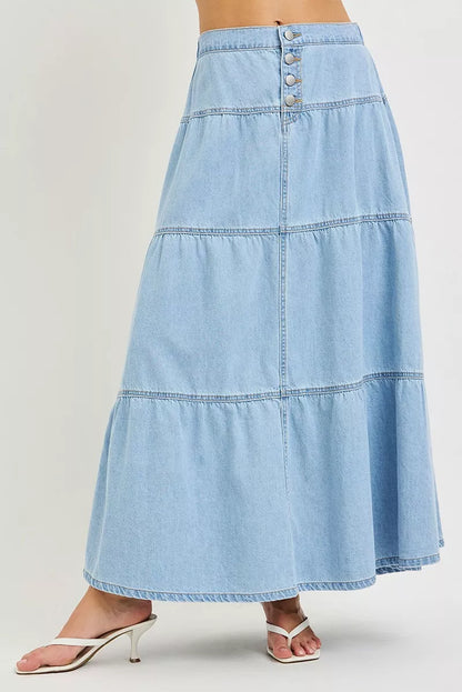 Light-colored RISEN high-rise ruffle long skirt by Trendsi, featuring flowing fabric and elegant ruffle details.