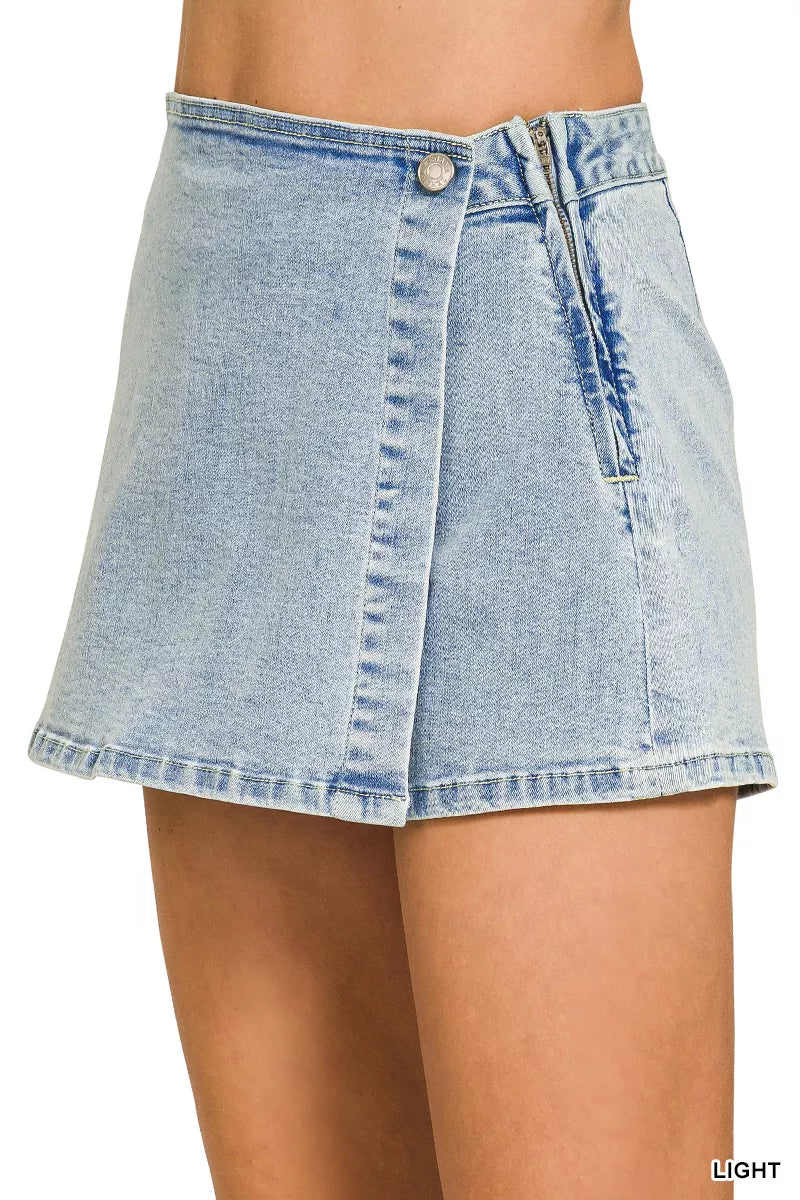 Light blue Zenana wrap-front denim skort from Trendsi, featuring a stylish front wrap design and classic denim texture.