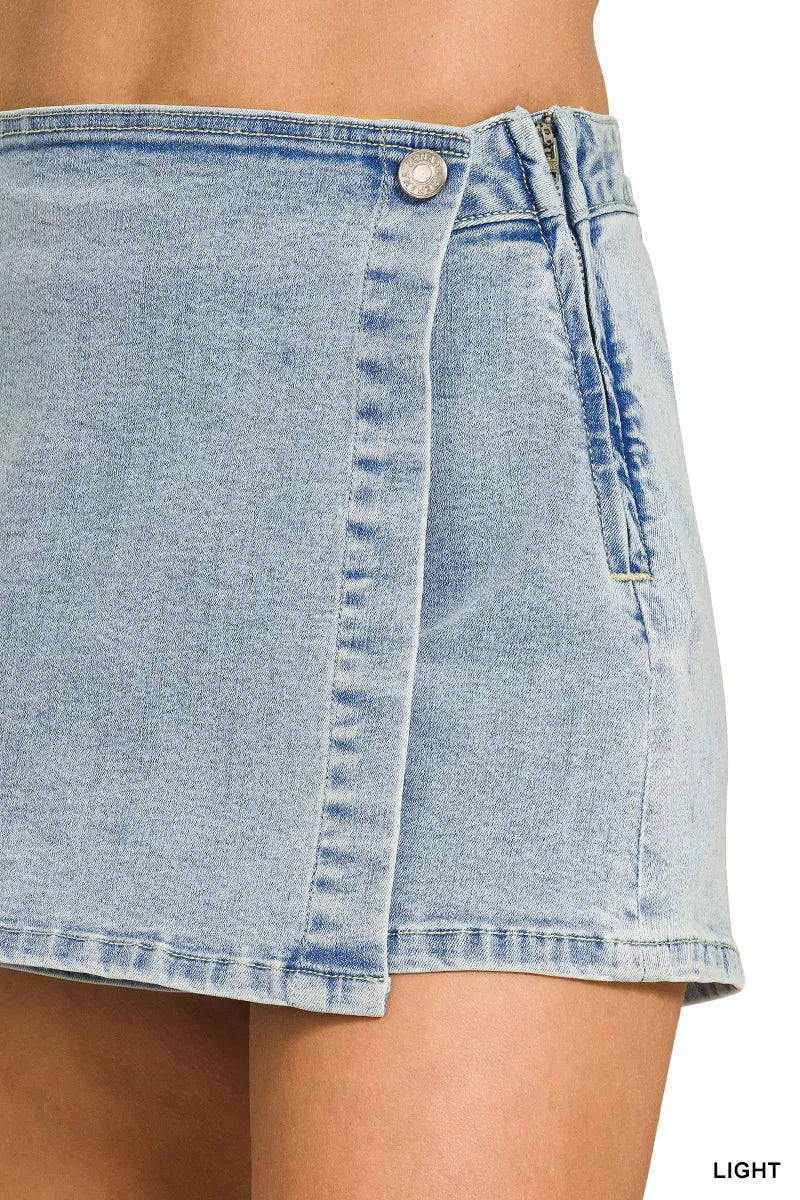 Light denim Zenana wrap-front skort by Trendsi, featuring a stylish front wrap design and classic denim fabric.