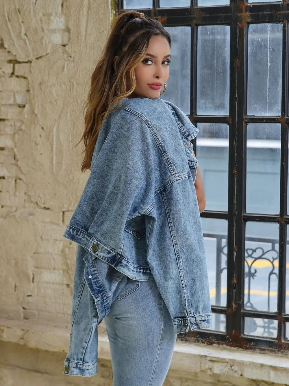 Light blue button-down denim jacket with drop shoulder design from Trendsi, featuring classic style and relaxed fit.
