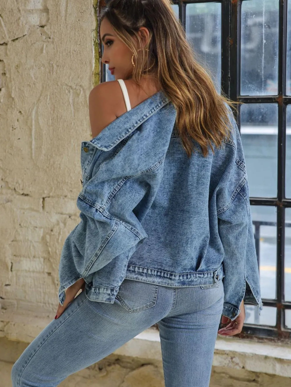 Light blue button-down denim jacket with drop shoulder design by Trendsi, shown on a model.