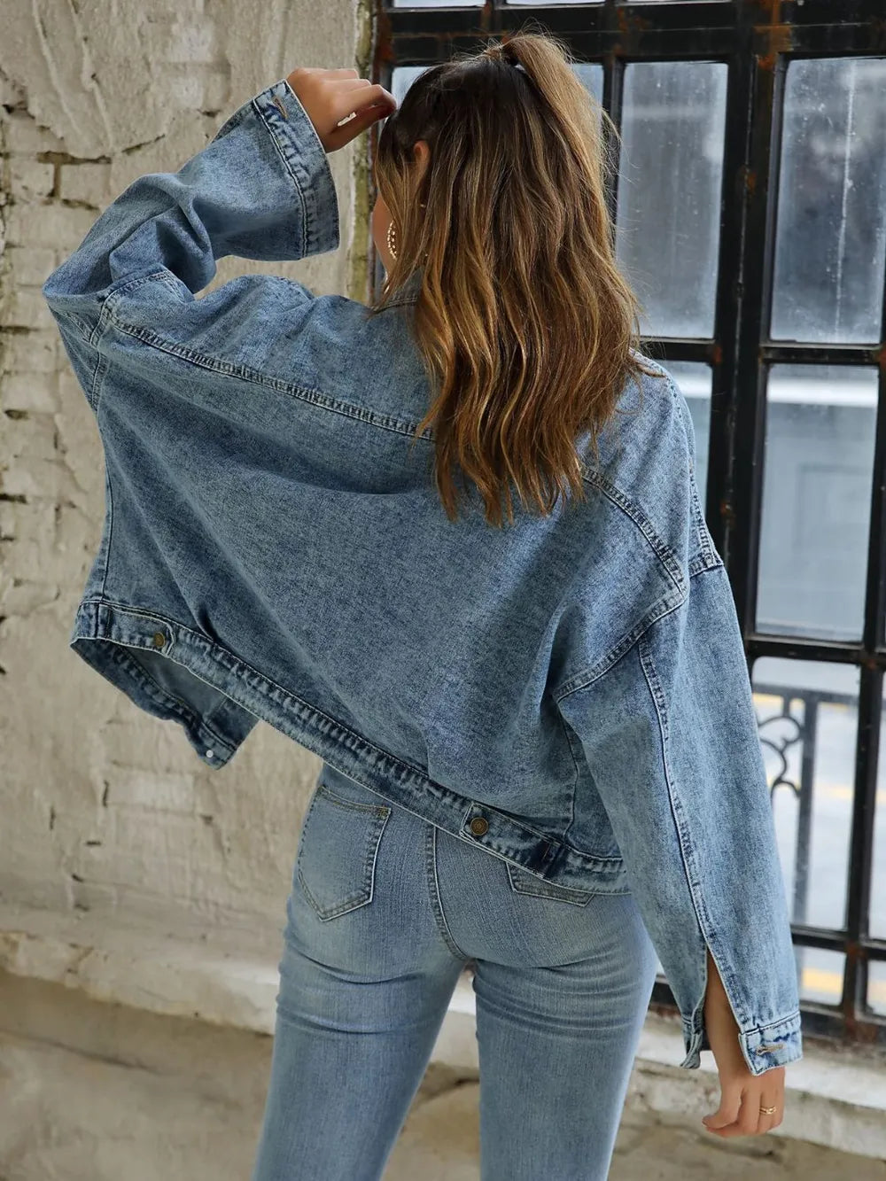 Light blue button-down drop shoulder denim jacket by Trendsi, featuring a casual fit and classic denim styling.