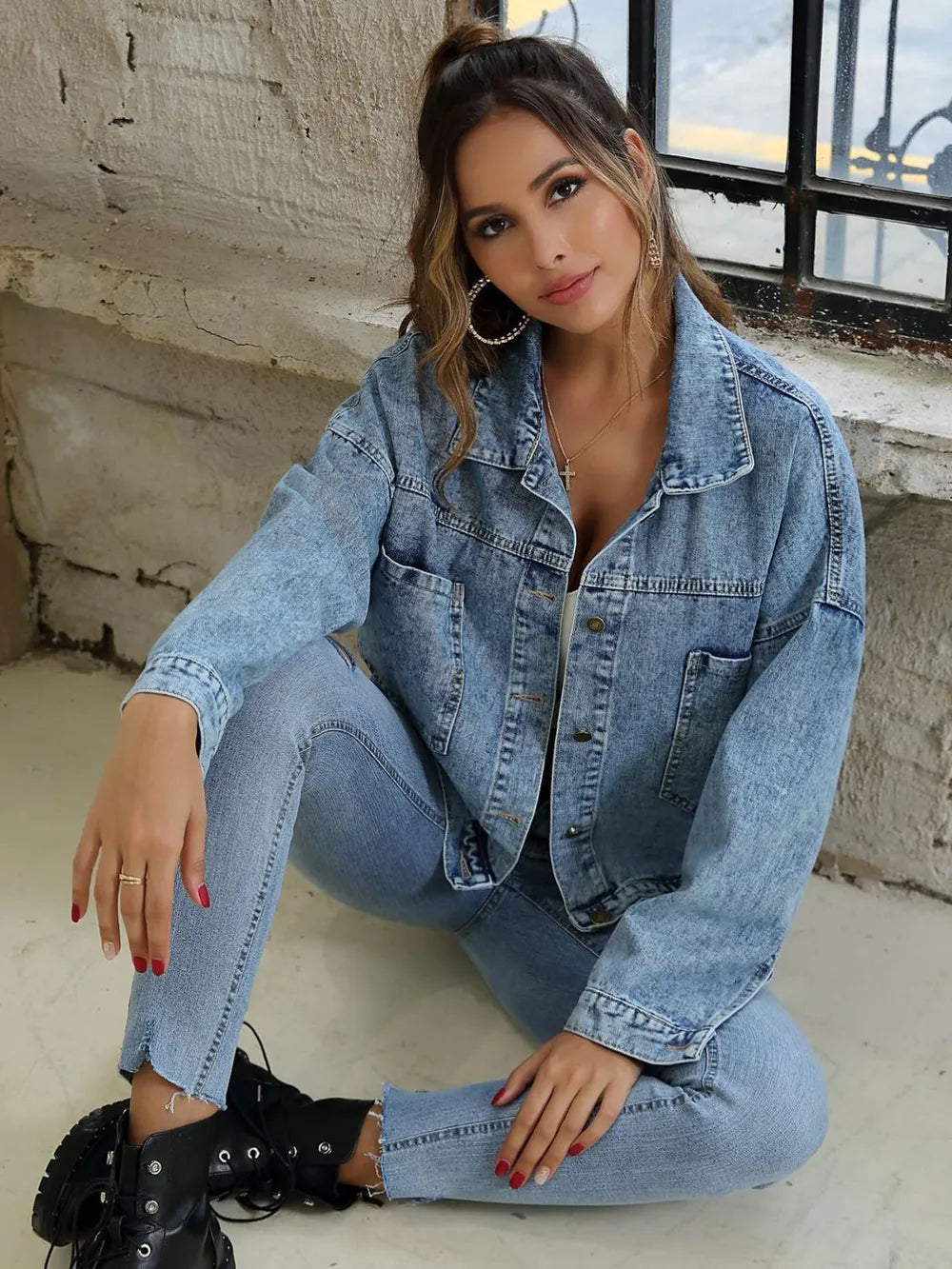 Light blue button-down denim jacket with drop shoulder design by Trendsi, shown on a model.